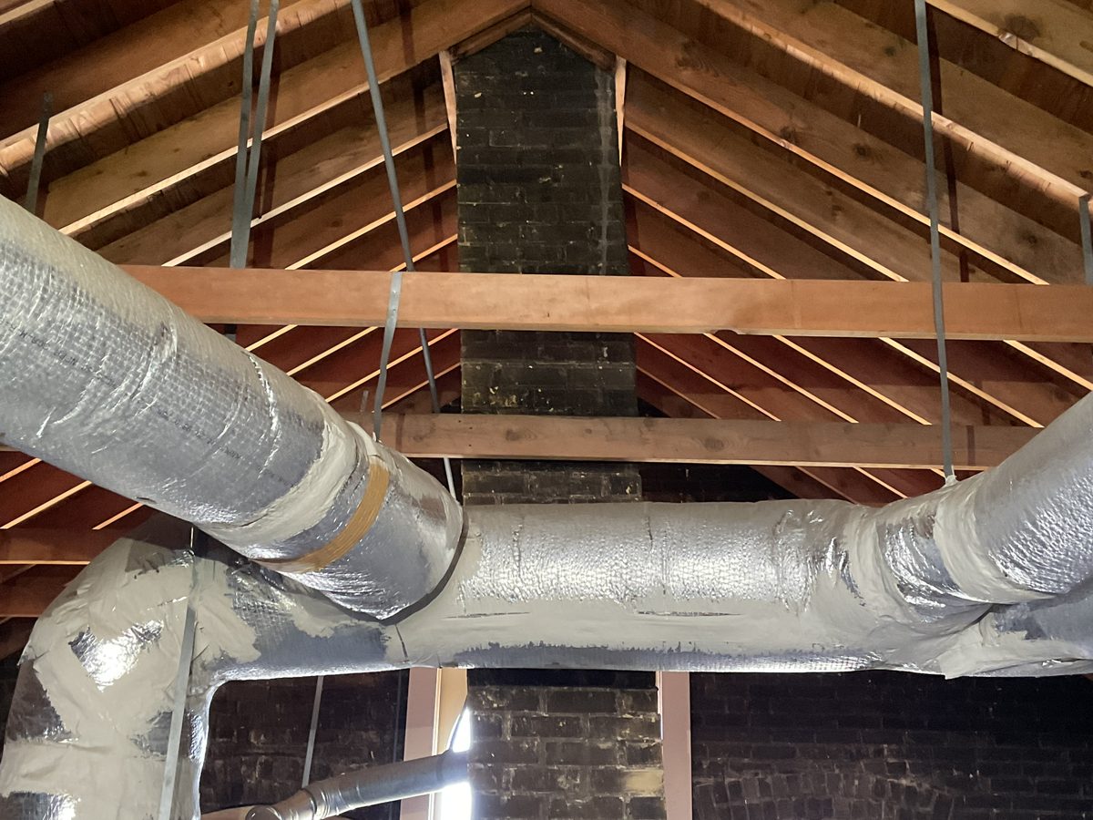 Attic framing, chimney and insulated HVAC ducts